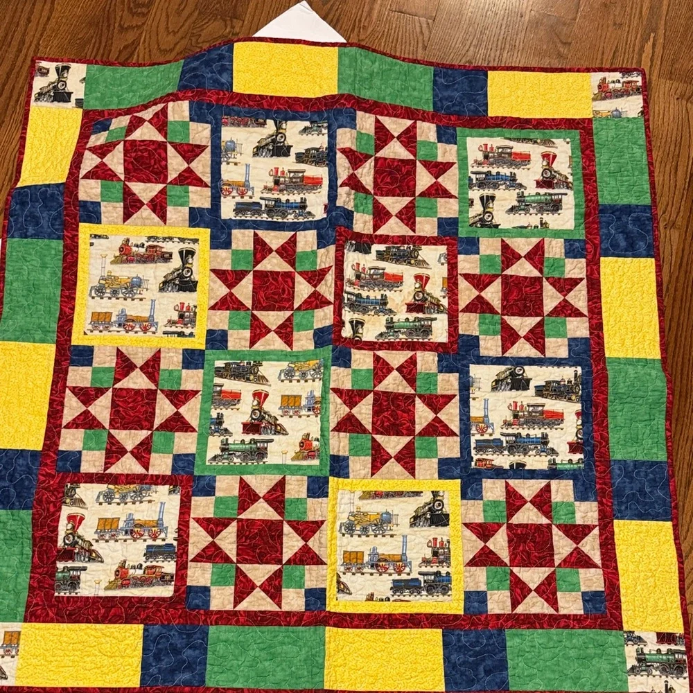 Handcrafted child's crib or lap quilt with trains and police cars firetrucks